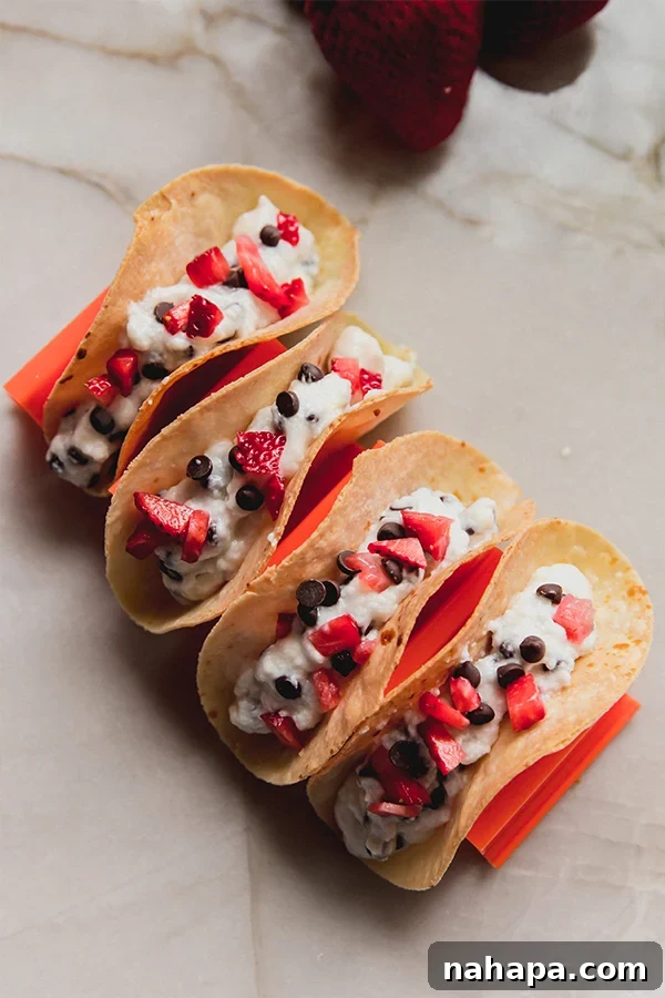 Close-up of three Cannoli Tacos with strawberries