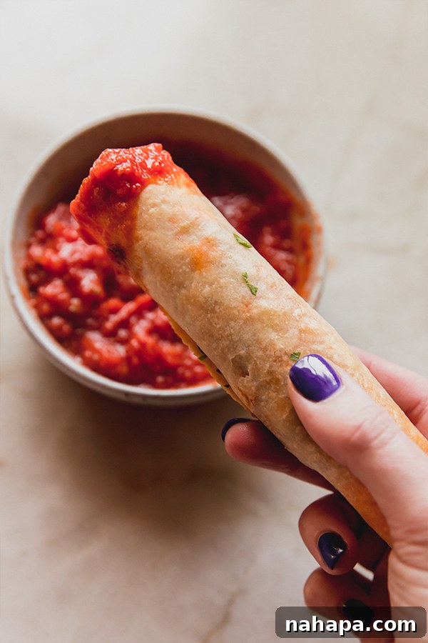Wholesome Gluten-Free Veggie Pizza Bites 7 Plated Air Fryer Veggie Pizza Roll-Ups garnished with fresh parsley and served with marinara dipping sauce