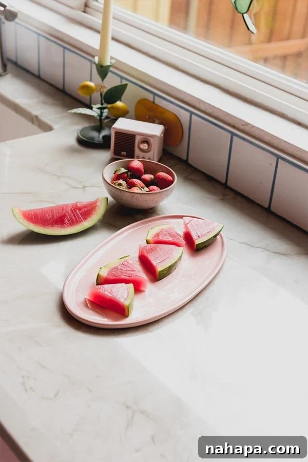Beautifully arranged watermelon jello slices on a simple serving plate, ready to enjoy