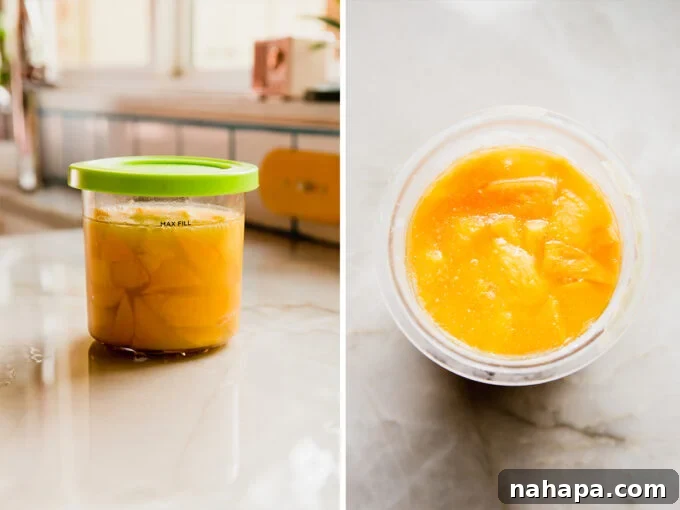 Close-up of creamy mango sorbet being scooped from a Ninja Creami pint into a bowl.