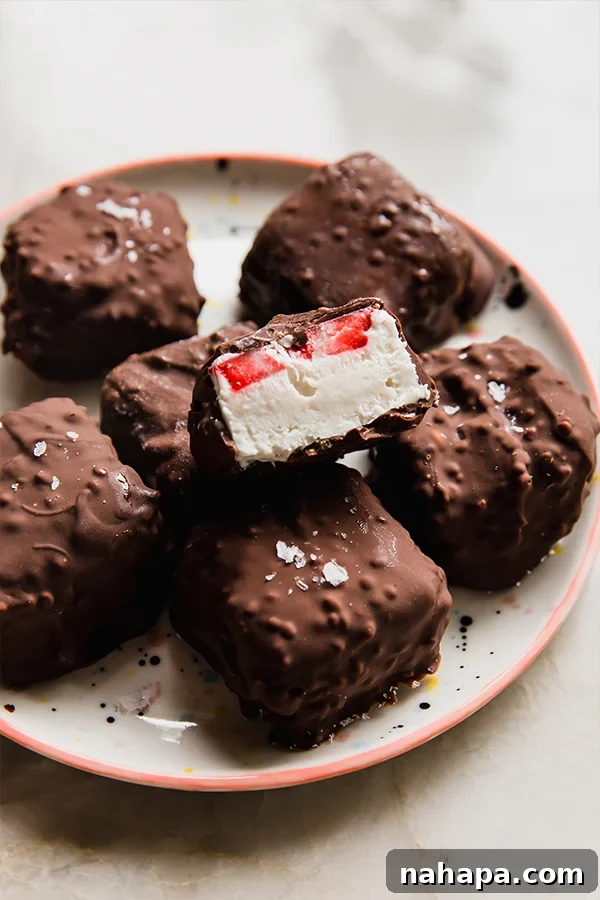 Dairy-Free Strawberry Crunch Ice Cream Bites on a white plate with fresh strawberries
