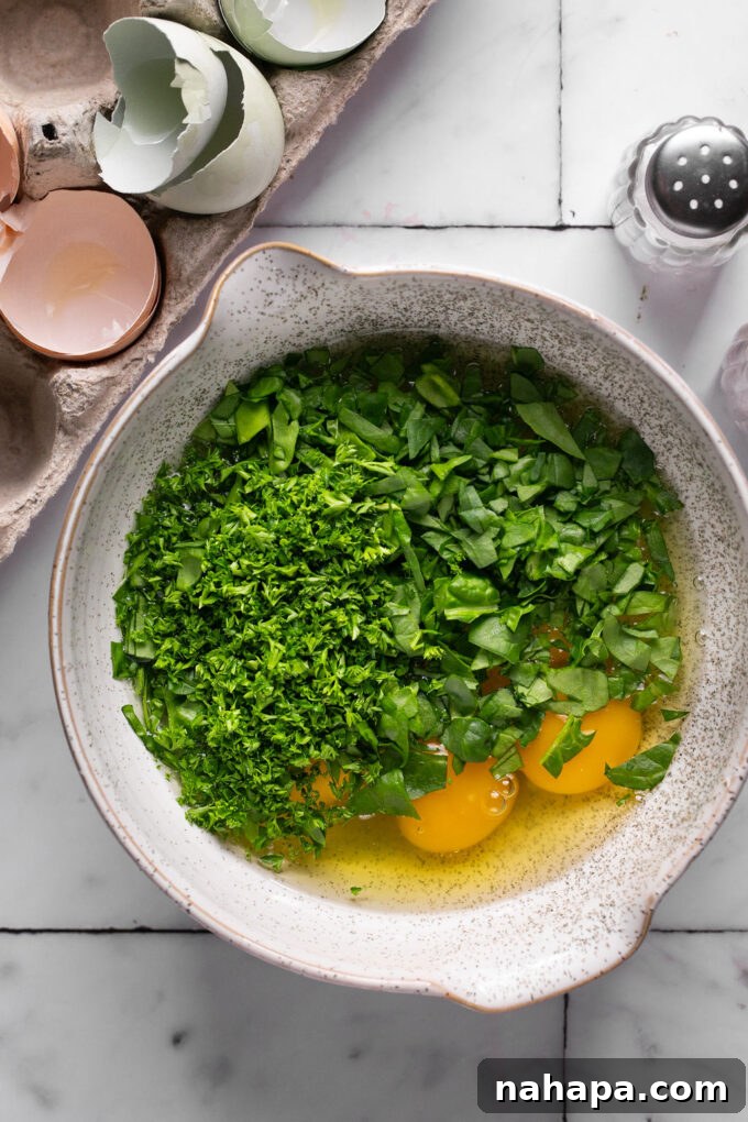 Whisking eggs with spinach and parsley