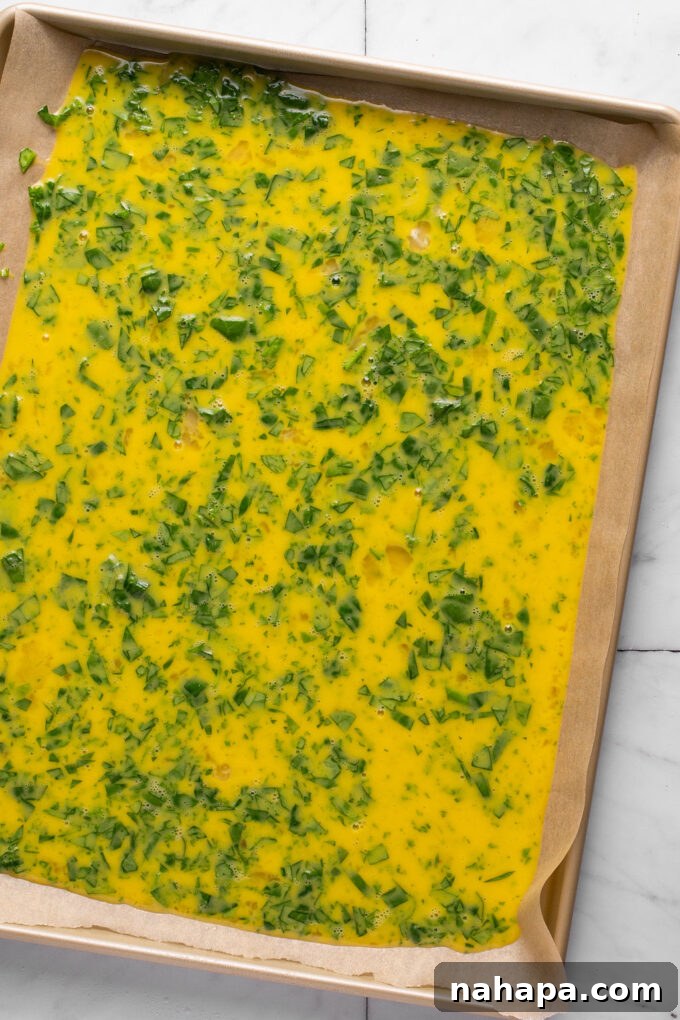 Pouring egg mixture onto sheet pan