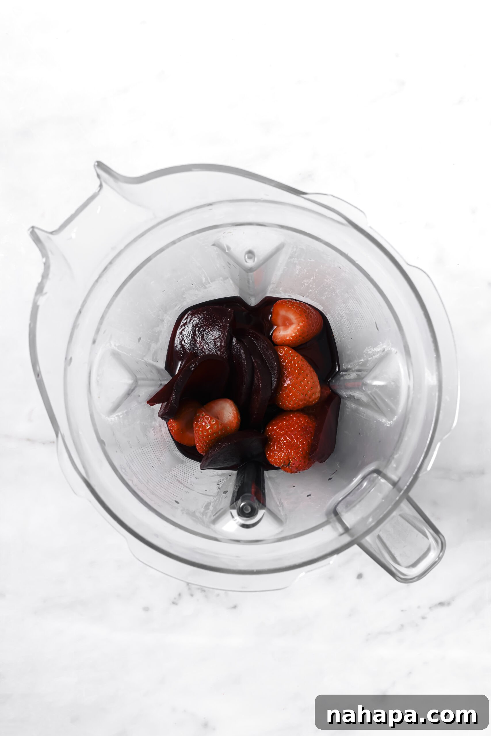 Blended strawberry-beet mixture in a blender jar
