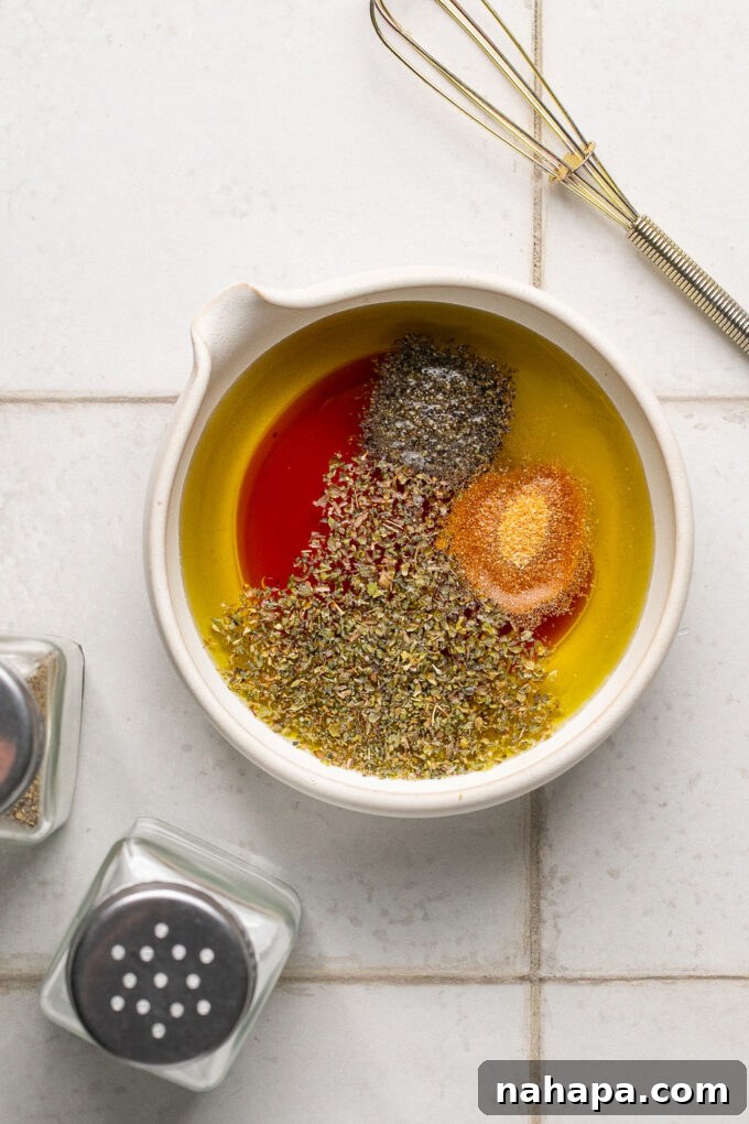 The dressing ingredients for sub in a tub before mixing, showing oil and vinegar separated.