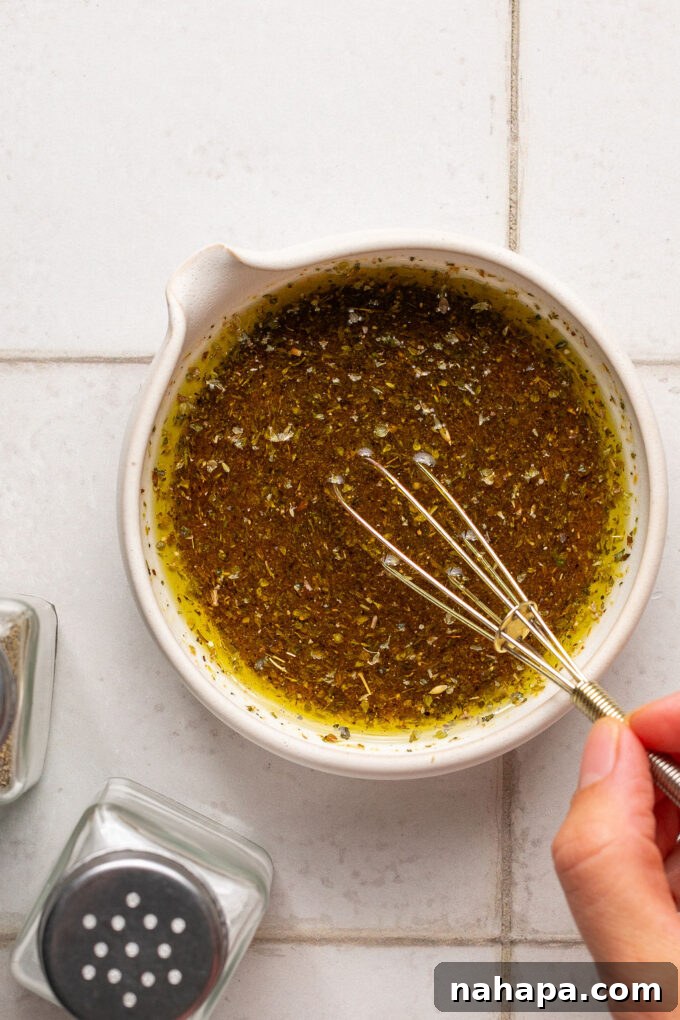 The dressing for sub in a tub after mixing, showing a well-emulsified vinaigrette.