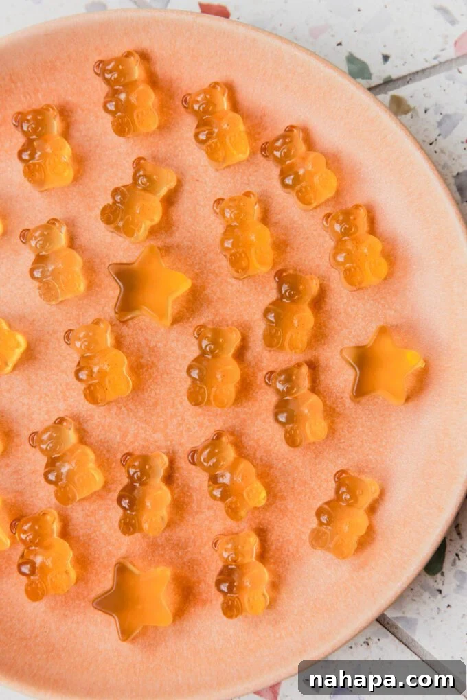 Apple cider vinegar gummy bears and stars on a pink plate.