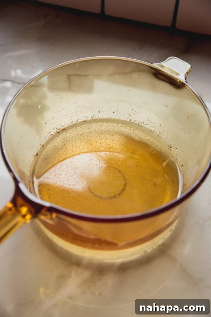 A bowl of the liquid to make the apple cider vinegar gummies.