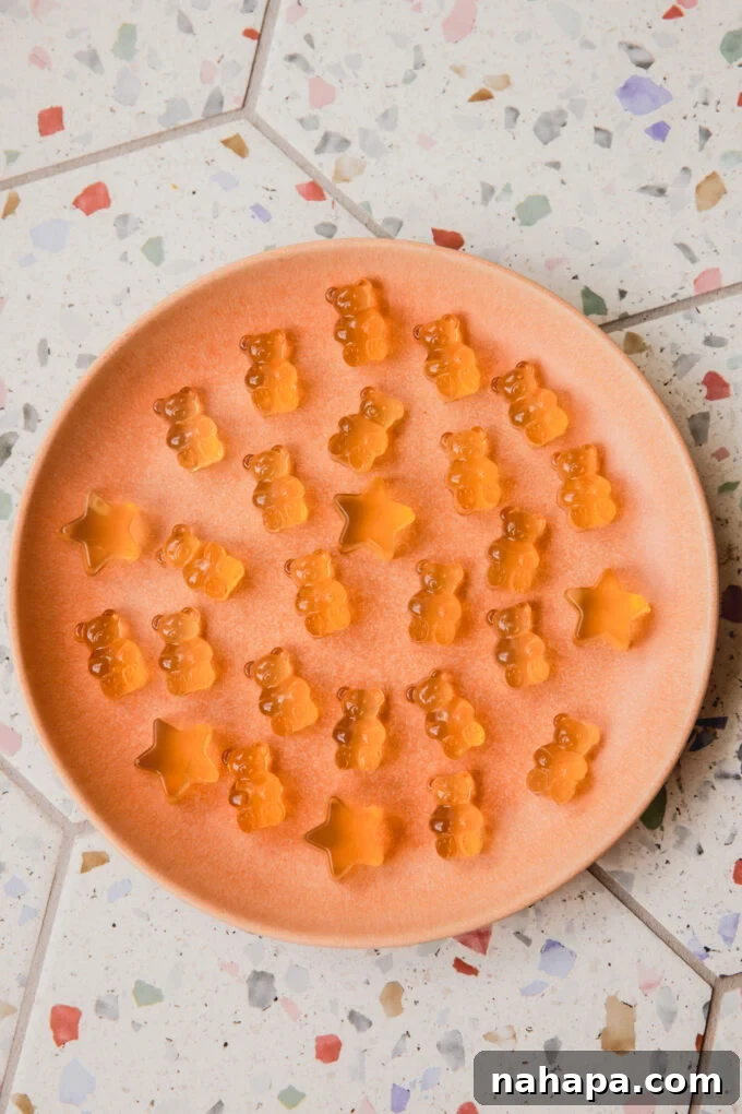 Apple cider vinegar gummy bears and stars on a pink plate.