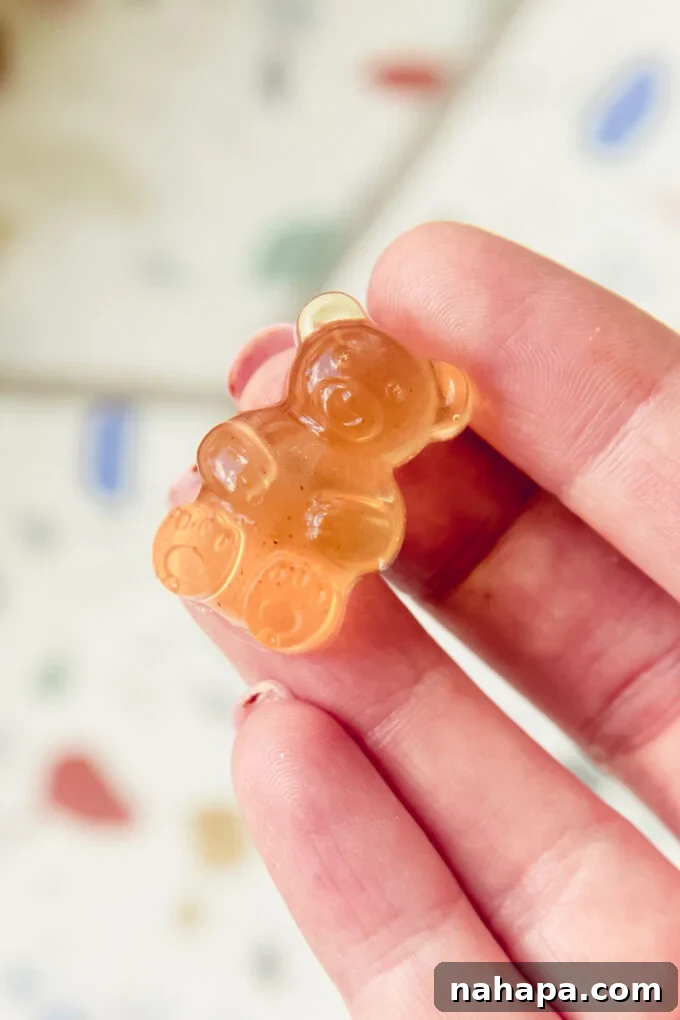 Apple cider vinegar gummy bear being held. 