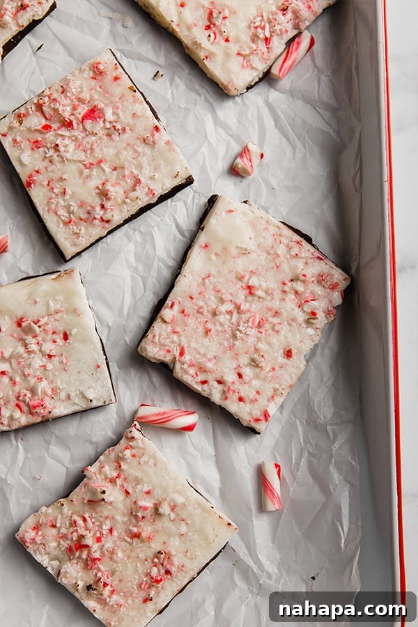 Delicious pieces of dairy-free and paleo peppermint bark arranged on a pristine white baking dish, ready to be enjoyed during the holidays.