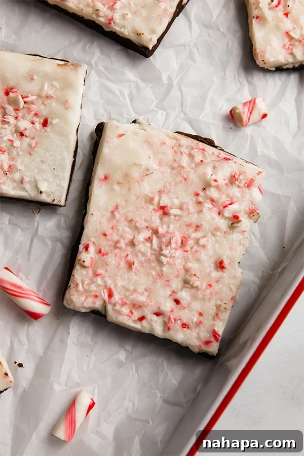 A close-up view of a single piece of dairy-free and paleo peppermint bark, showcasing its distinct layers and tempting texture.
