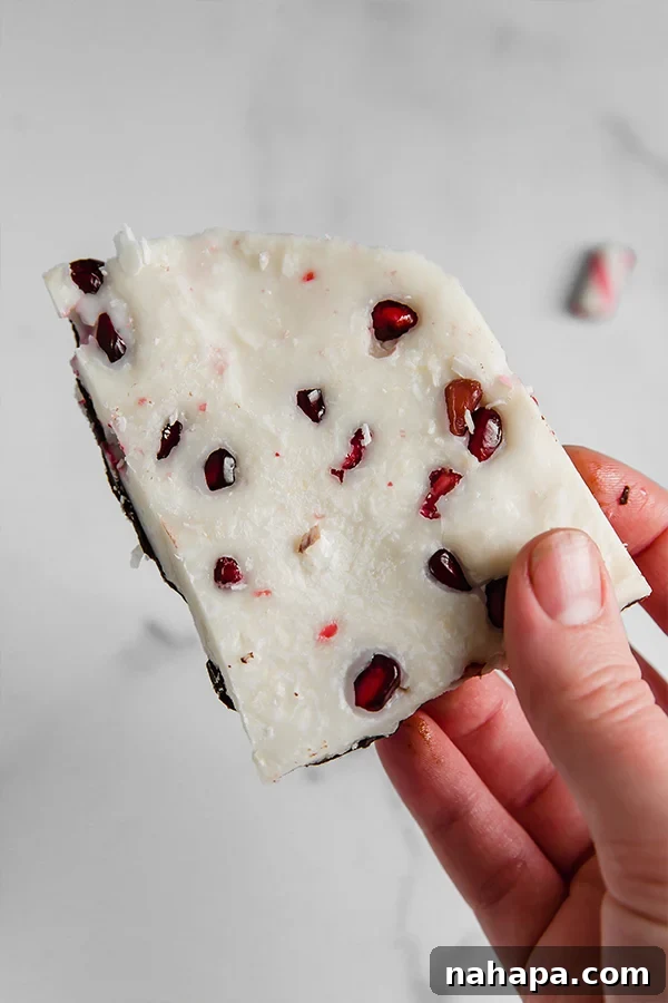 Paleo Peppermint Bark topped with vibrant pomegranate seeds, offering a delicious and AIP-friendly twist on the classic holiday treat.
