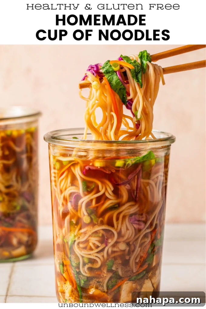 Elevated Gluten-Free Noodle Cups: Healthy Homemade Comfort 13 Homemade cup of noodles with ramen, veggies and broth in a glass jar with chopsticks pulling the noodles.