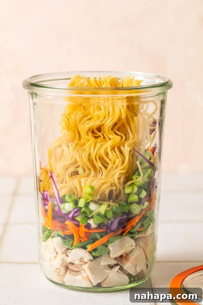 Elevated Gluten-Free Noodle Cups: Healthy Homemade Comfort 6 Cooked chicken, veggies, green onion and a brick of gluten free ramen layered in a glass jar.