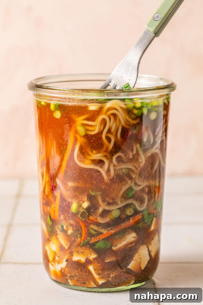 Elevated Gluten-Free Noodle Cups: Healthy Homemade Comfort 10 Homemade cup of noodles in a glass jar with a fork dipping in.