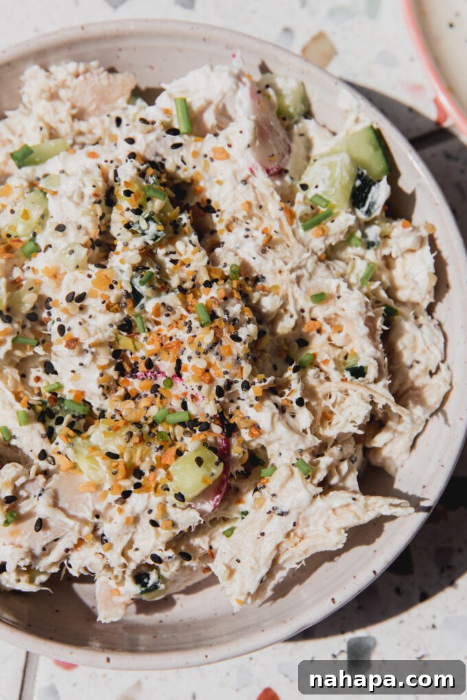 Everything Bagel Crunch Chicken Salad Dairy Free 3 Bagel chicken salad topped with everything bagel seasoning in a bowl, close up.