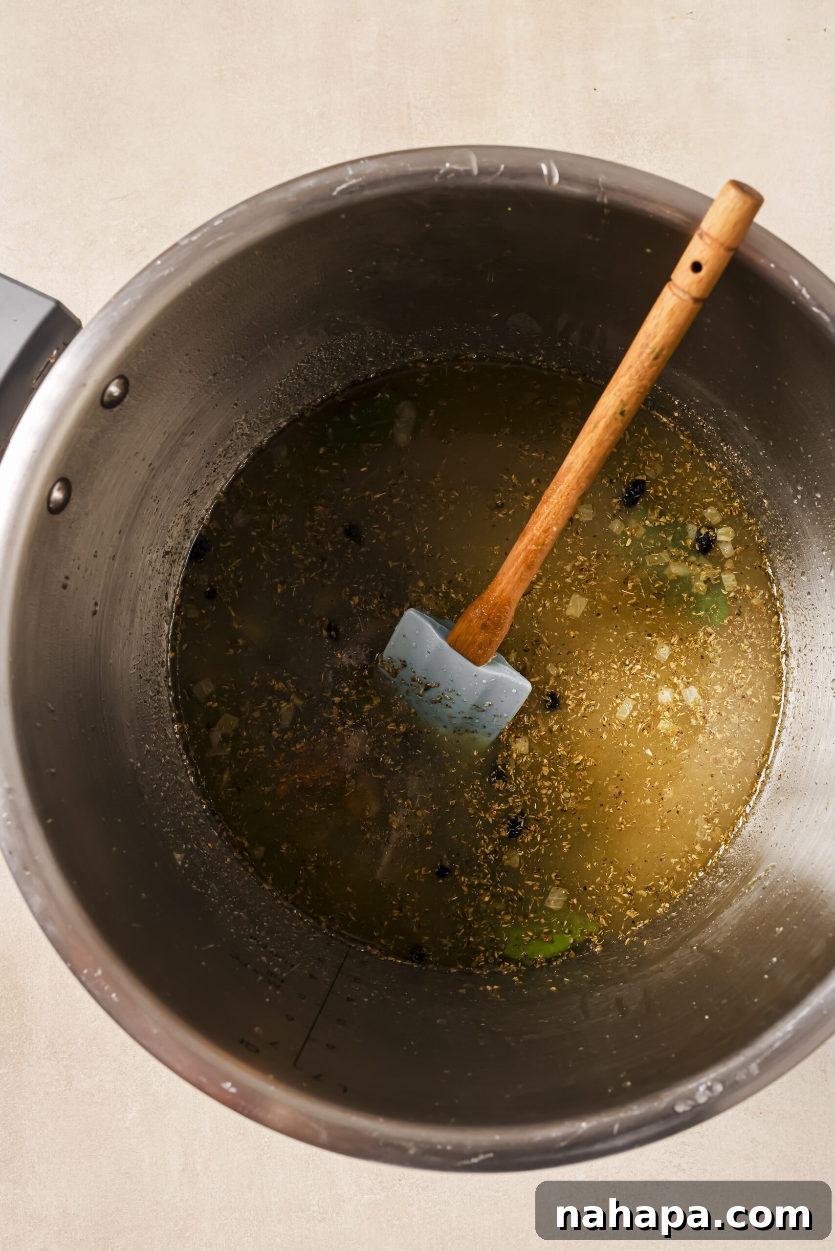 Sautéed onions with broth and herbs in a pressure cooker.