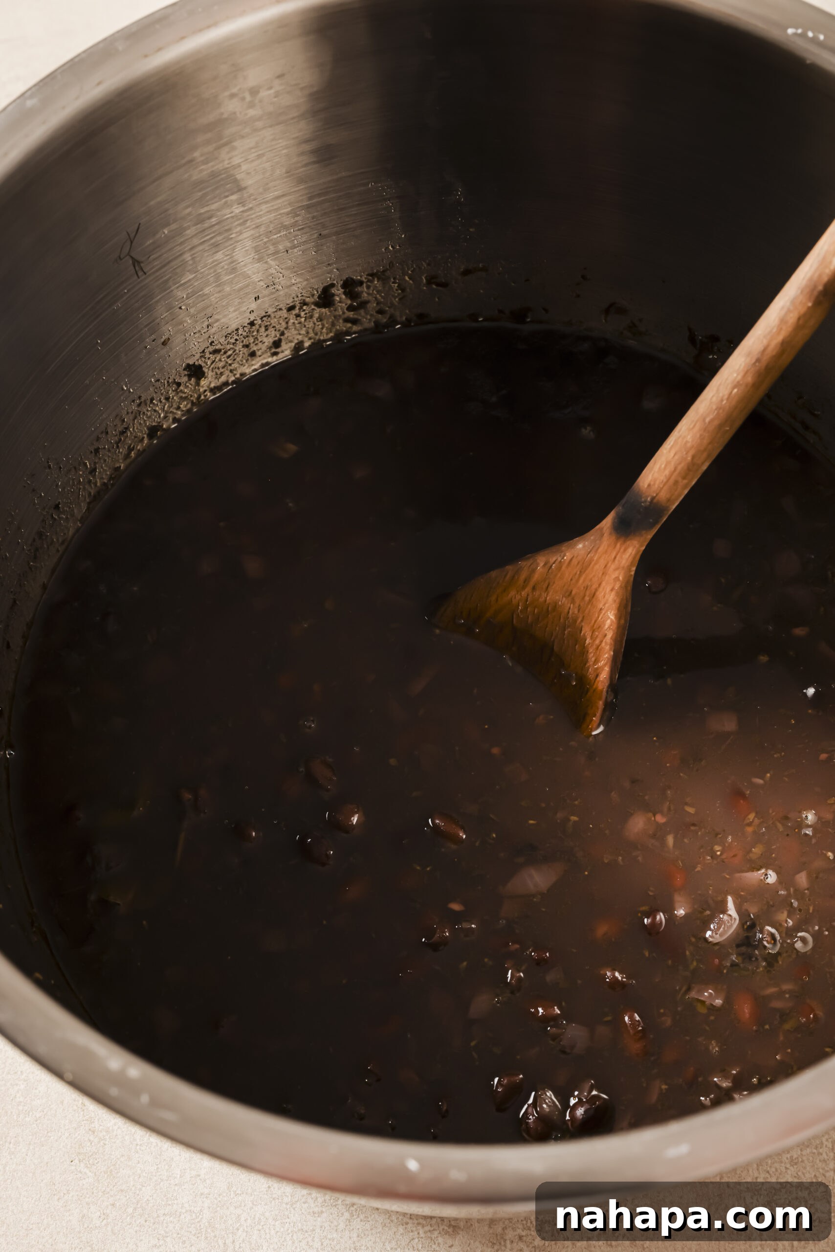 Cooked refried beans in an instant pot with extra broth.