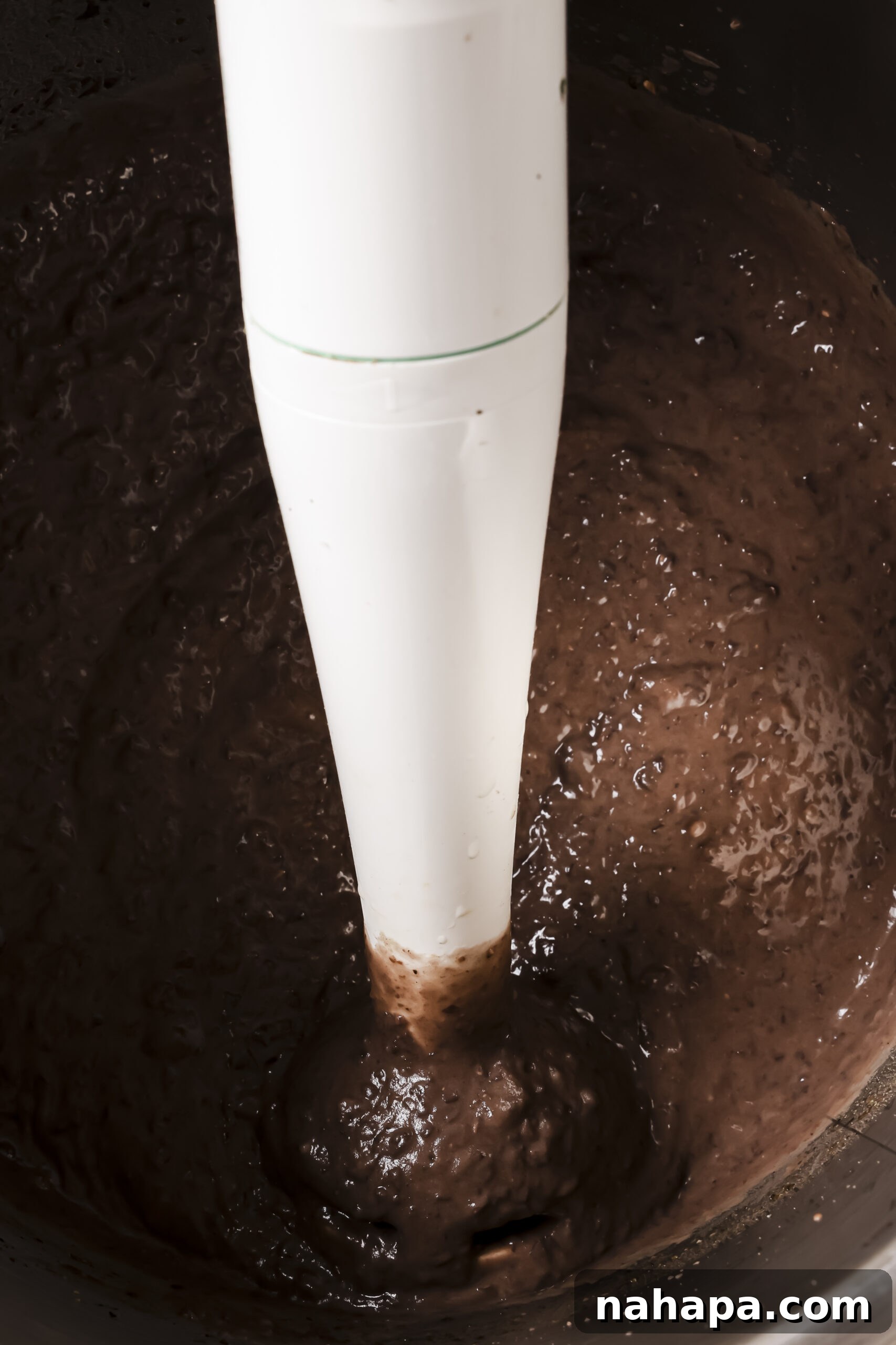 Cooked refried beans in an instant pot with extra broth strained out and blending with an immersion blender.