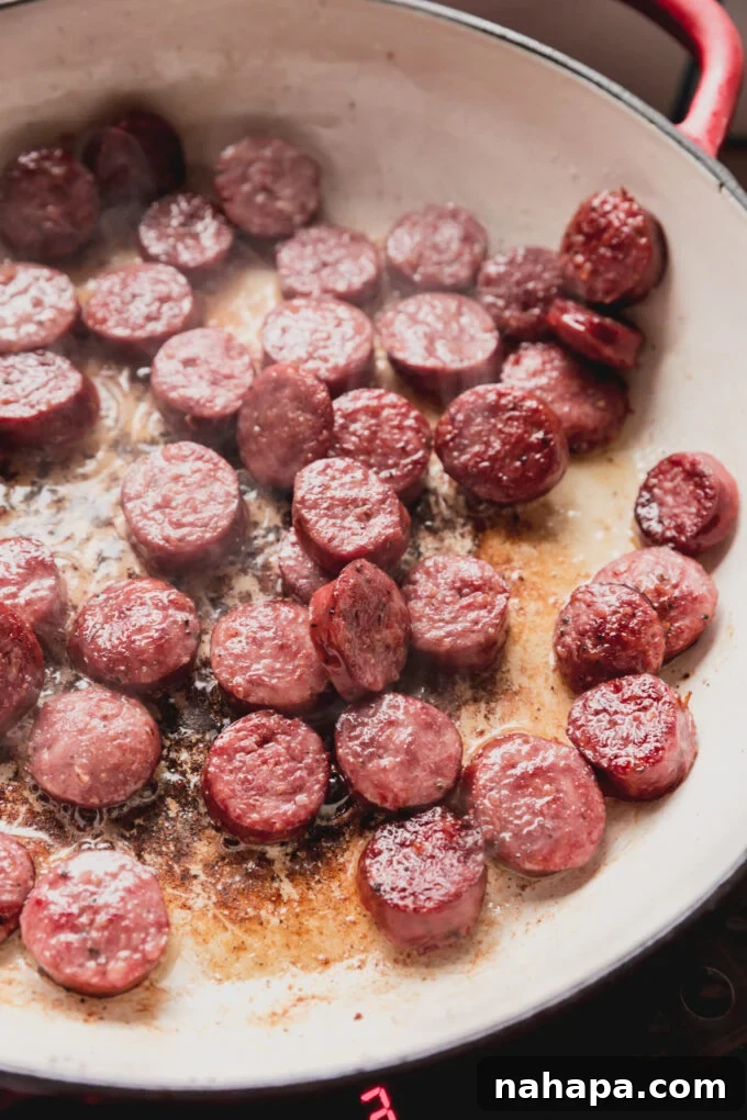 Down-Home Skillet Cabbage and Sausage 5 Perfectly browned and crispy smoked sausage pieces in a pan after cooking.