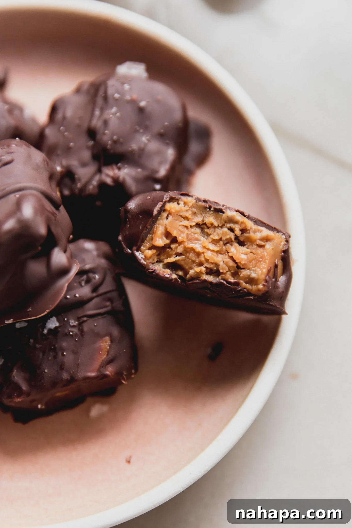 Mini butterfinger copycats on a platter with one bitten in half.