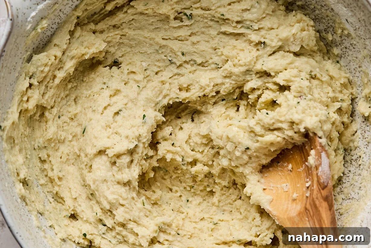 Mixed gluten-free dumpling dough in a bowl, ready for scooping.