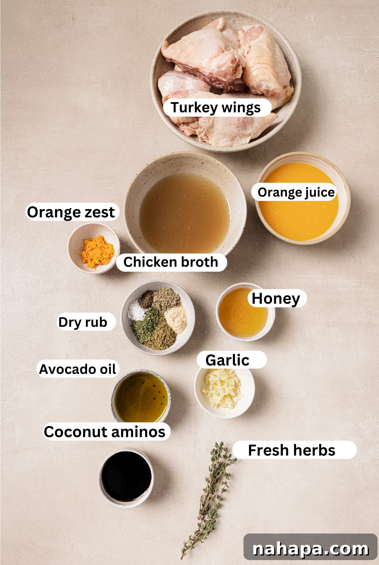 The ingredients for baked turkey wings and an orange glaze laid out in separate bowls.