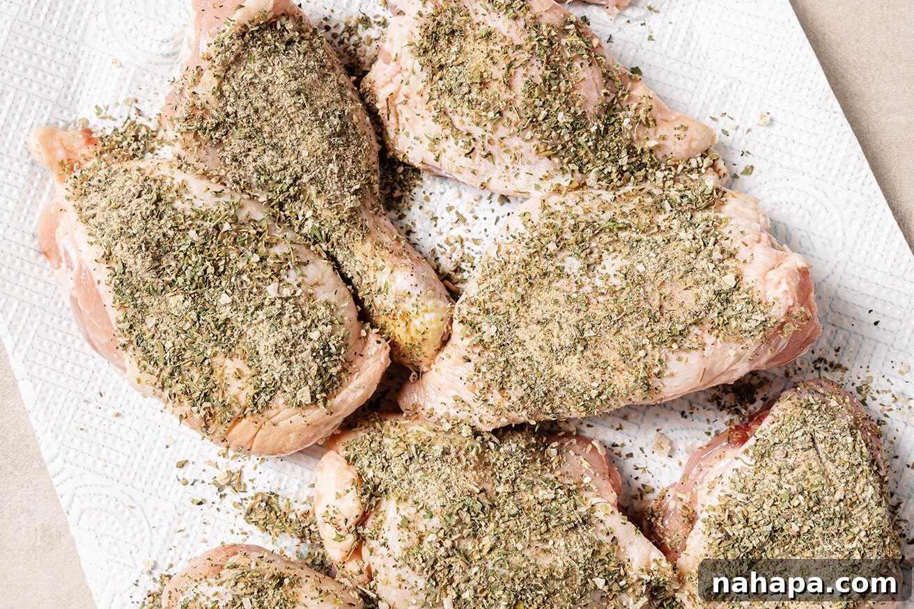 Raw turkey wings coated in a herb dry rub.