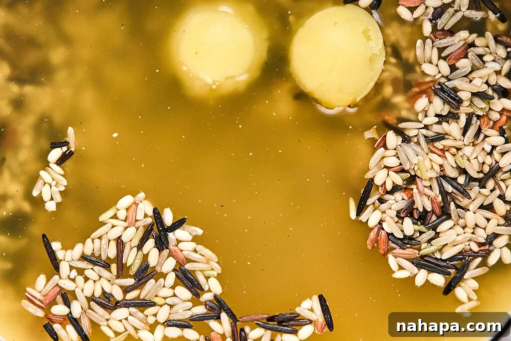 Uncooked wild rice in broth with ghee.