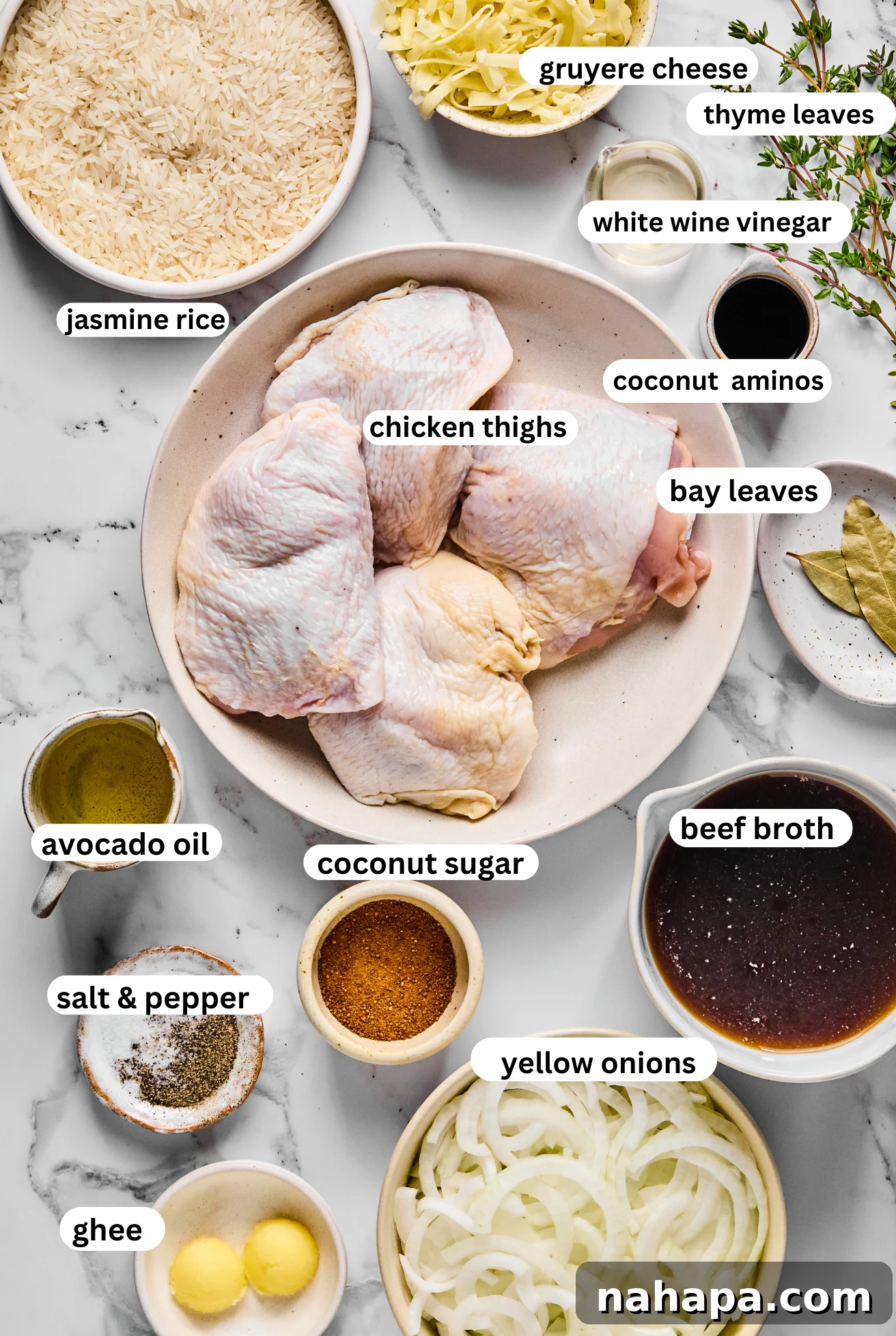 All the fresh ingredients laid out for preparing French onion chicken and rice, including chicken thighs, onions, rice, and cheese.
