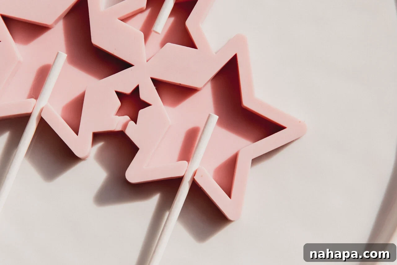 Star-shaped lollipop mold with lollipop sticks inserted, awaiting the hot syrup.