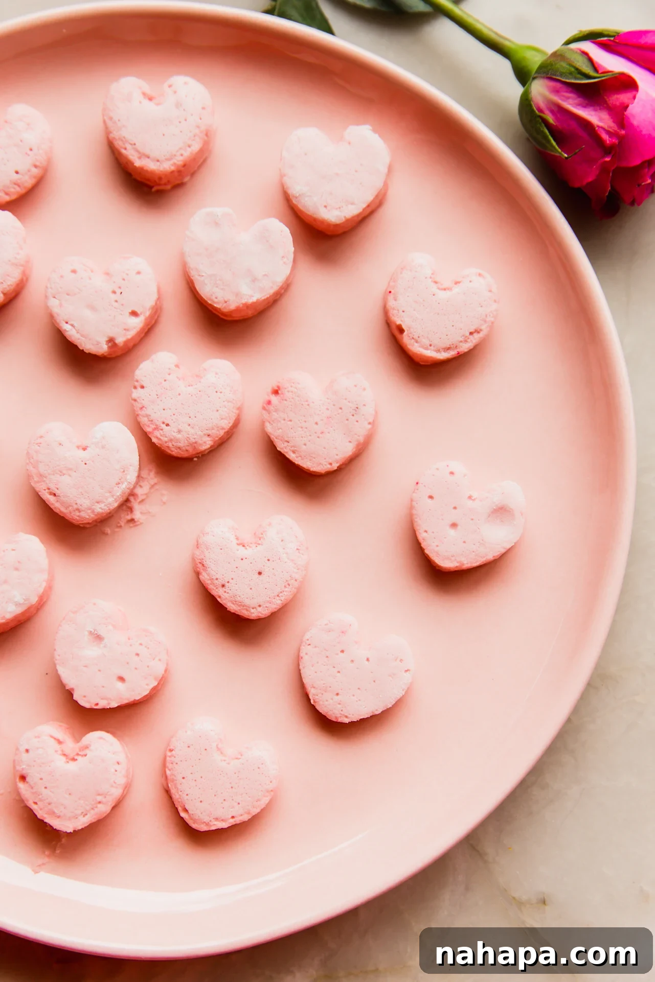 Sweet Pink Cloud Bites 2 Pink heart shaped marshmallows on a pink plate.