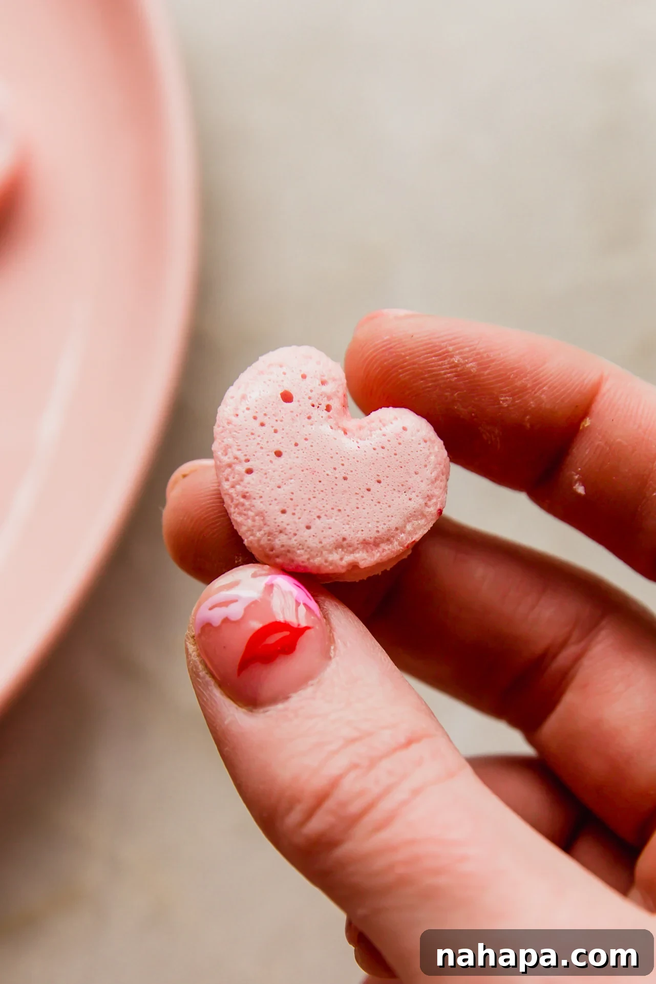 Sweet Pink Cloud Bites 8 hand holding one homemade heart shaped pink marshmallow