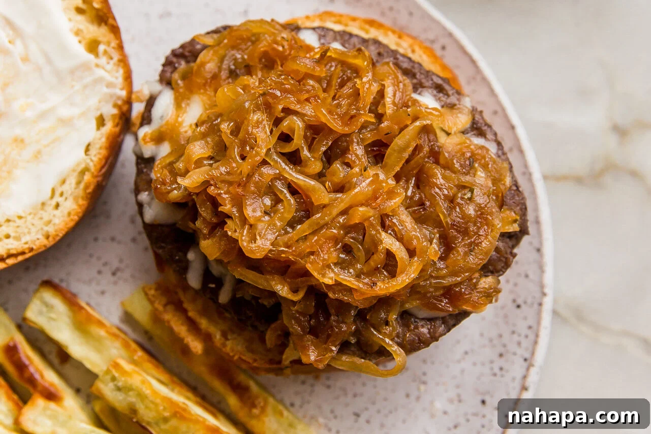 French onion burger on a bun, served open face.
