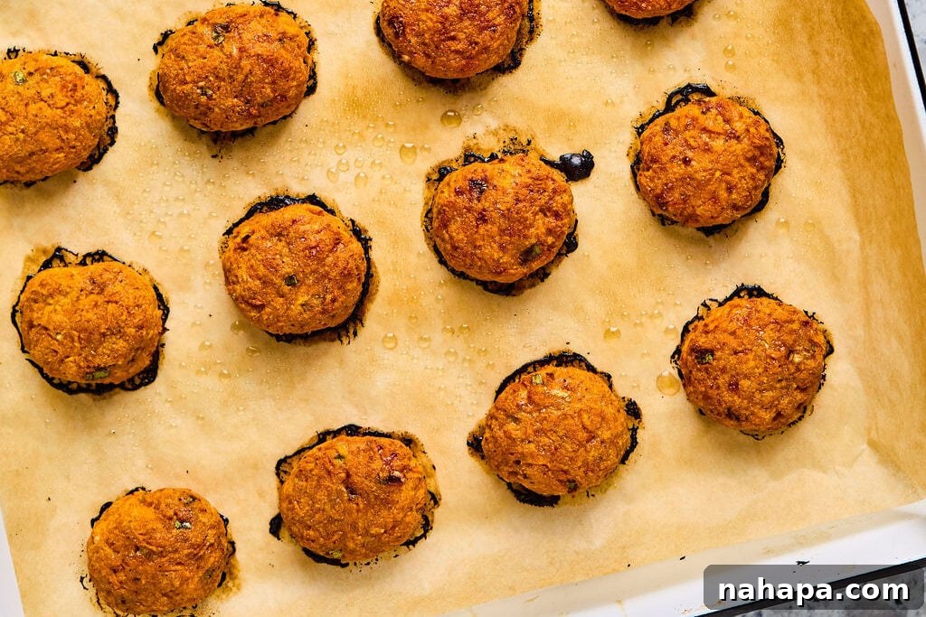 Cooked sweet potato chicken poppers on a sheet pan. 