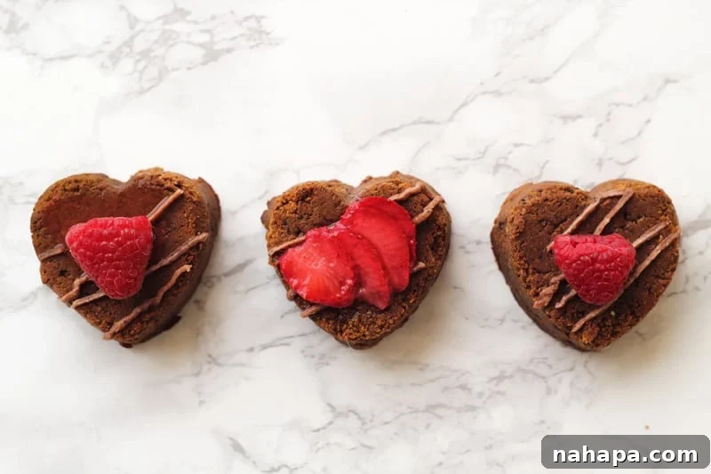 AIP Valentine's Brownies Guilt-Free Love Bites 5 AIP Brownies in heart shapes with icing and strawberries.