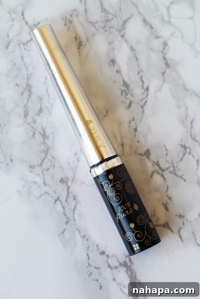 January Wellness Picks 4 A chic container of 100 Percent Pure liquid eyeliner displayed on a elegant marble background.