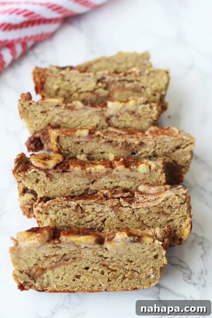 A perfectly baked loaf of Easy Plantain Banana Bread, suitable for AIP, Paleo, and Vegan diets, showcased on a wooden cutting board.