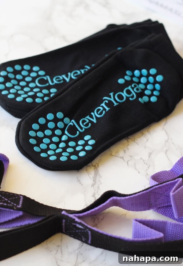 A pair of grippy yoga socks and a versatile yoga strap, ready for practice.