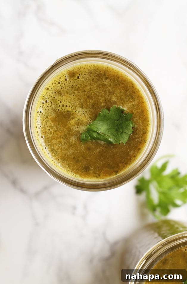 Green Bone Broth Elixir 3 A glass jar filled with green bone broth drink.