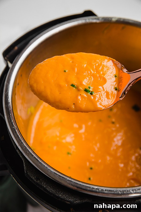 A vibrant bowl of Carrot Leek Turmeric Soup, presented beautifully, ready for a comforting meal.