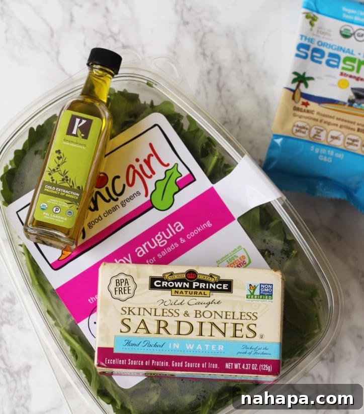 Your Paleo & AIP Travel Food Guide & Checklist 4 A container of arugular, olive oil, sardines, and seaweed snacks out on a countertop.