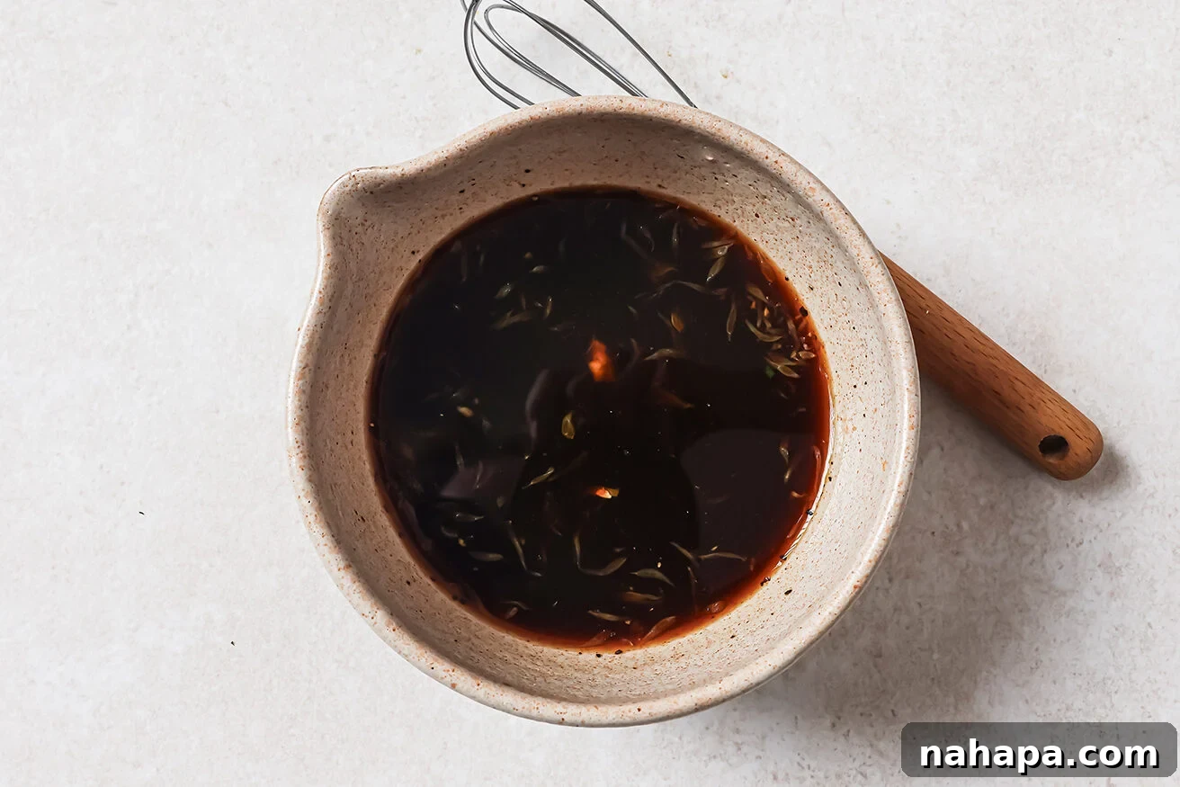 A small bowl containing the freshly whisked orange chicken sauce, ready to be added to the cooked chicken.