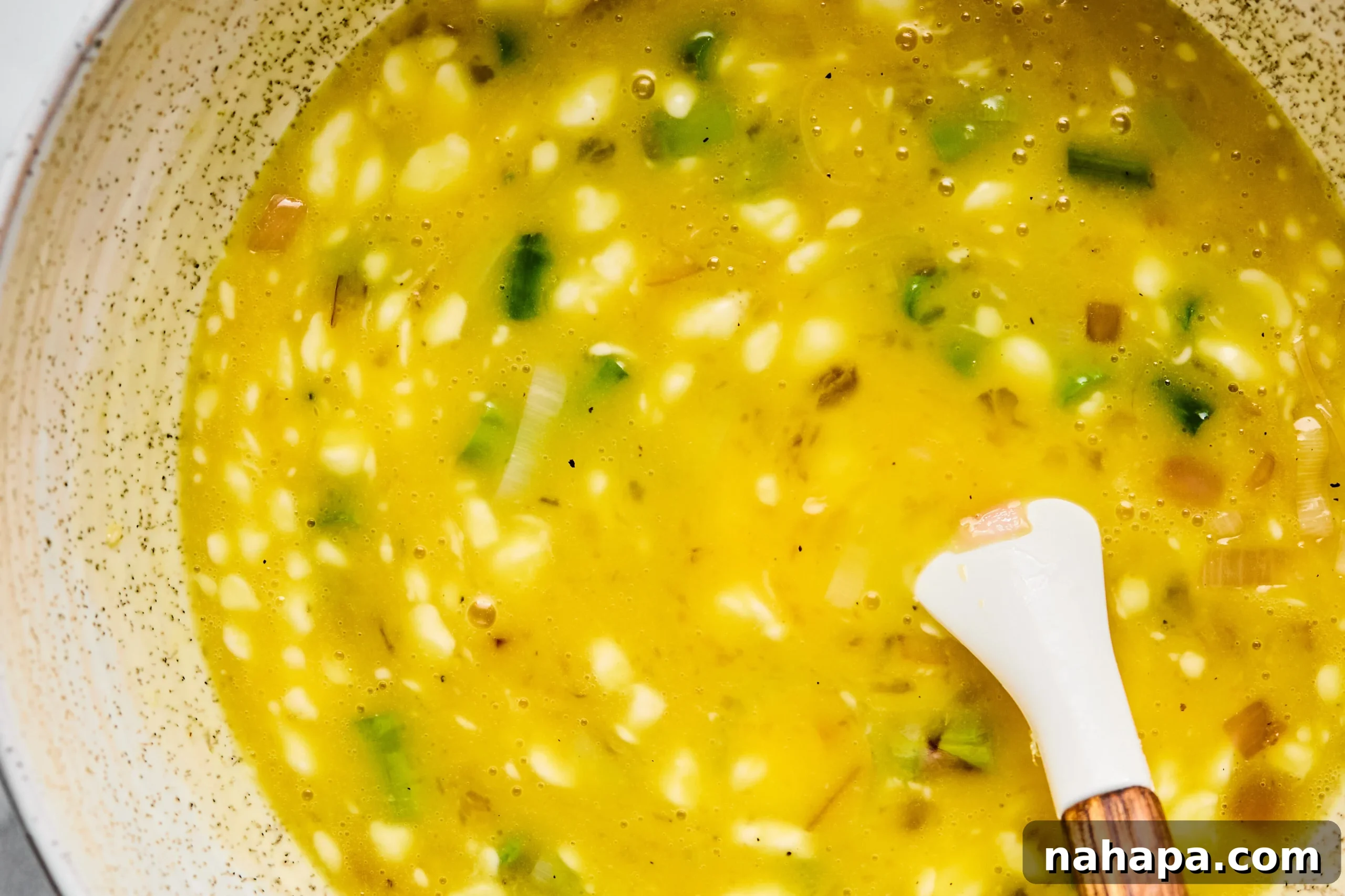 The egg mixture in a bowl before adding to the quiche.