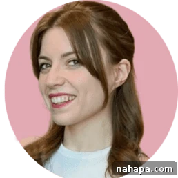 Food blogger Michelle Hoover smiling, with a pink background, radiating warmth and approachability.