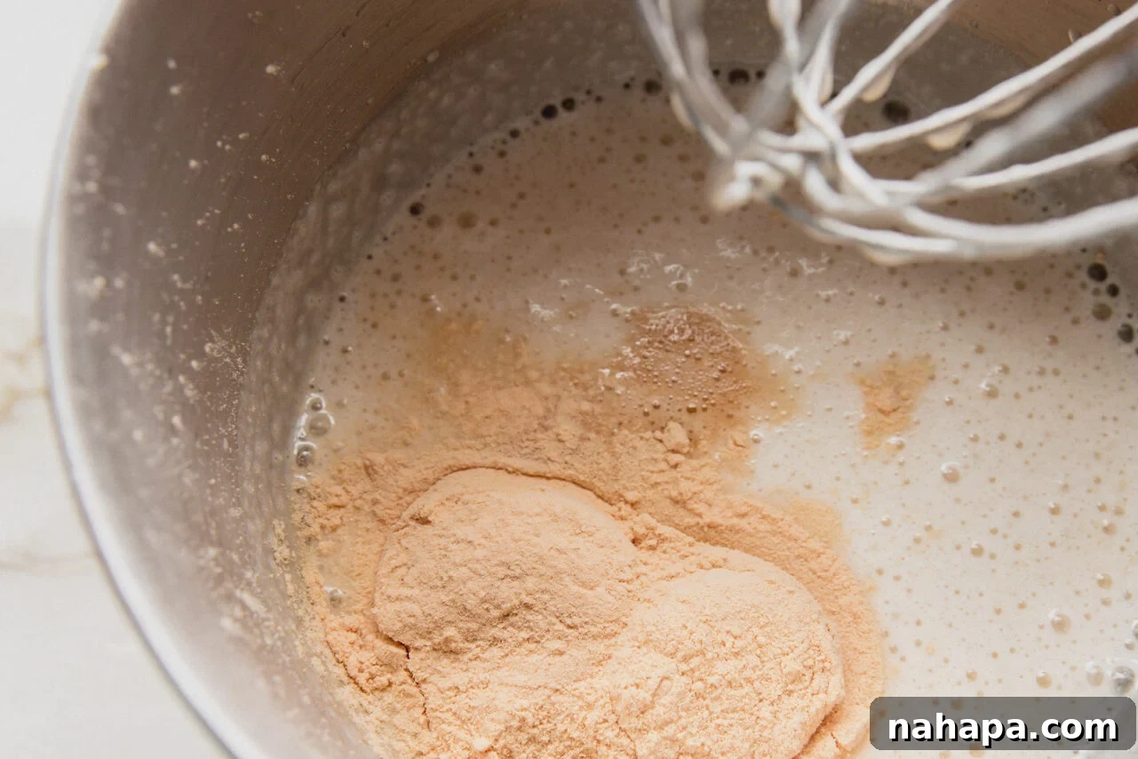 The initial ingredients for the protein marshmallow layer, including almond milk, gelatin, and cane sugar, sitting in a pot before heating.