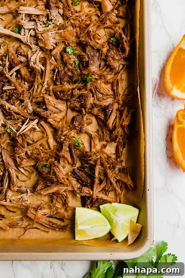 Close up of shredded slow cooker carnitas in a bowl