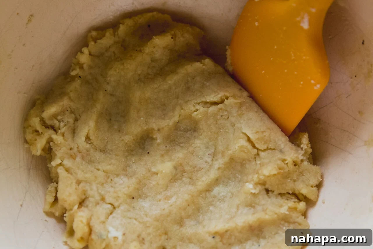 Gluten-free dough ingredients mixed in a bowl, forming a soft, cohesive dough.