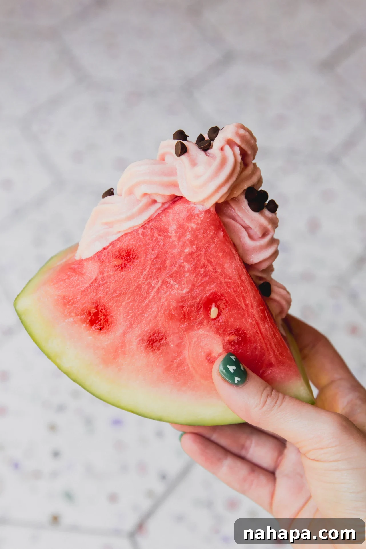 Watermelon Dream Swirl 2 A beautifully swirled Watermelon Dole Whip served inside a hollowed-out watermelon wedge, showcasing a vibrant red color and perfect soft-serve texture. The image evokes summer refreshment and a delightful treat.